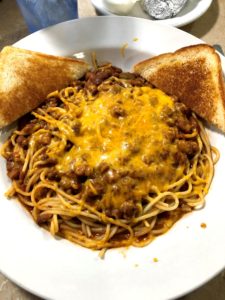 Chili and Cheese on Spaghetti with two triangles of garlic toast